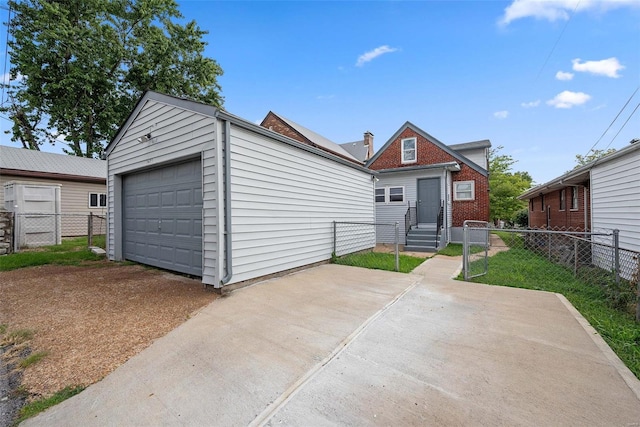 view of front of house featuring fence, entry steps, and a garage