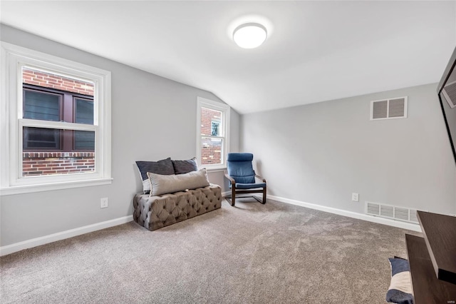 sitting room with vaulted ceiling, carpet, and baseboards