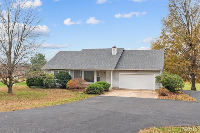330 Osage Dr, Union, MO 63084 - view of front of property with asphalt driveway, an attached garage, a chimney, and a front lawn