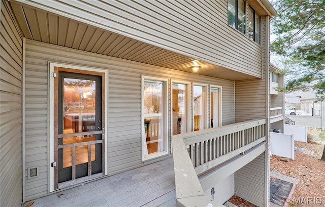 view of exterior entry featuring a wooden deck