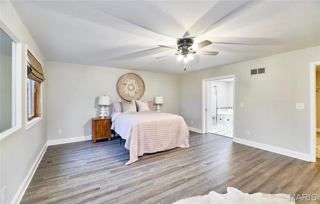 bedroom featuring wood finished floors, baseboards, ensuite bathroom, and ceiling fan