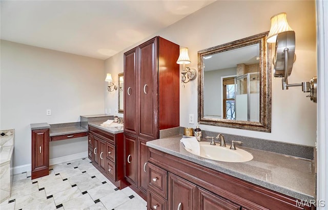 bathroom with two vanities, tile patterned flooring, a shower stall, and baseboards