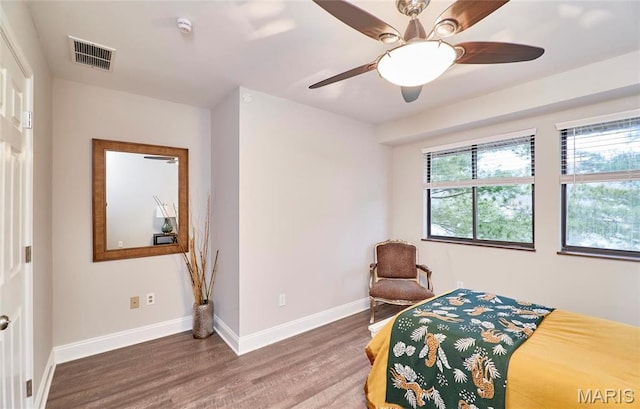 bedroom featuring wood finished floors, baseboards, and a ceiling fan