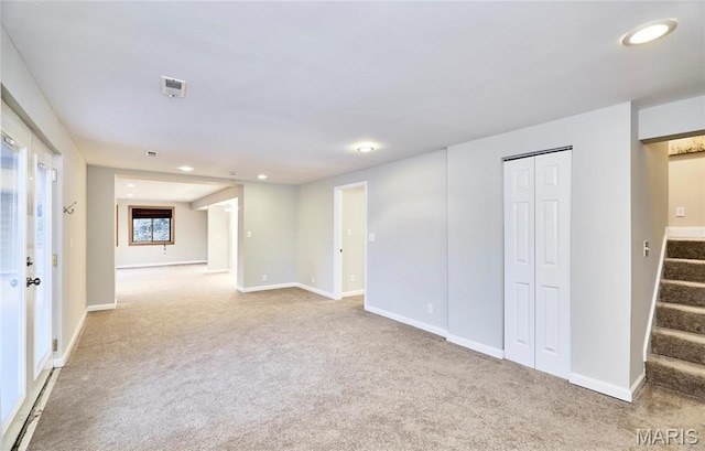 unfurnished living room featuring carpet flooring, stairway, recessed lighting, and baseboards