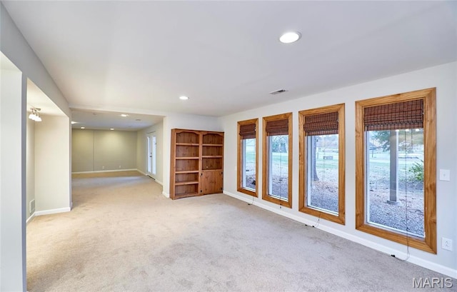 unfurnished room featuring baseboards, carpet floors, healthy amount of natural light, and recessed lighting
