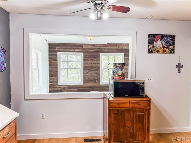 121 Douglas Dr, Pleasant Hill, IL 62366 - interior space featuring stainless steel microwave, a ceiling fan, baseboards, and light wood-type flooring