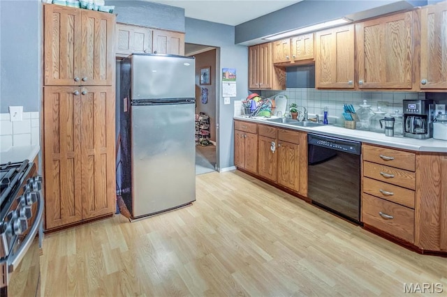 121 Douglas Dr, Pleasant Hill, IL 62366 - kitchen with stainless steel appliances, a sink, light wood-style flooring, decorative backsplash, and light countertops