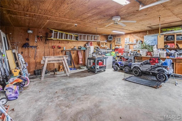 121 Douglas Dr, Pleasant Hill, IL 62366 - garage with a workshop area, wooden walls, and a ceiling fan