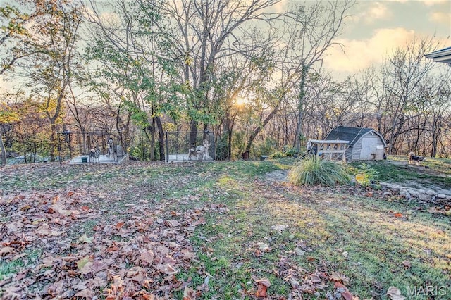 121 Douglas Dr, Pleasant Hill, IL 62366 - yard at dusk featuring a storage shed and an outdoor structure