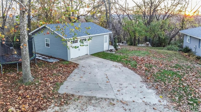 121 Douglas Dr, Pleasant Hill, IL 62366 - garage at dusk featuring concrete driveway and a garage
