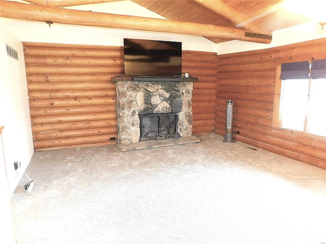 unfurnished living room featuring carpet, beamed ceiling, and a fireplace