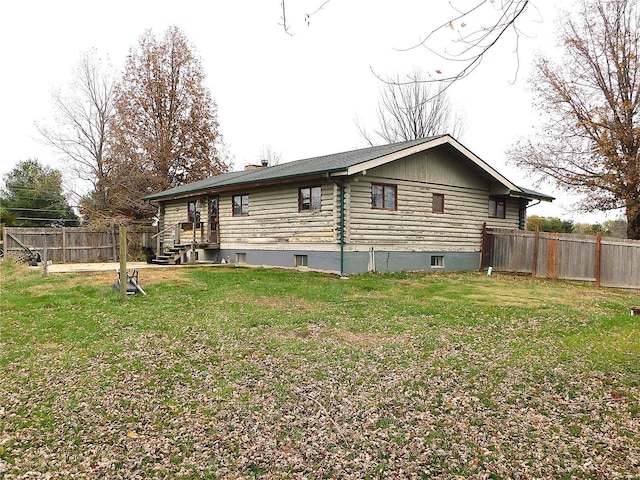back of property featuring log exterior and a chimney