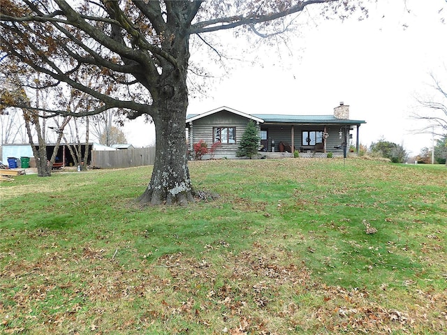 view of front facade with a chimney and a porch