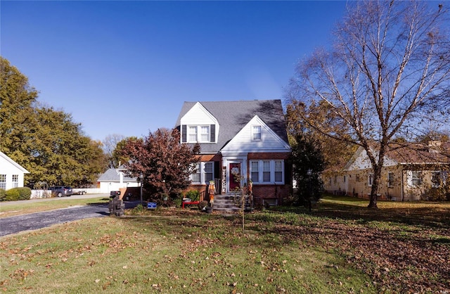 1040 N Kingshighway, Sikeston, MO 63801 - cape cod house featuring brick siding, a front lawn, and asphalt driveway