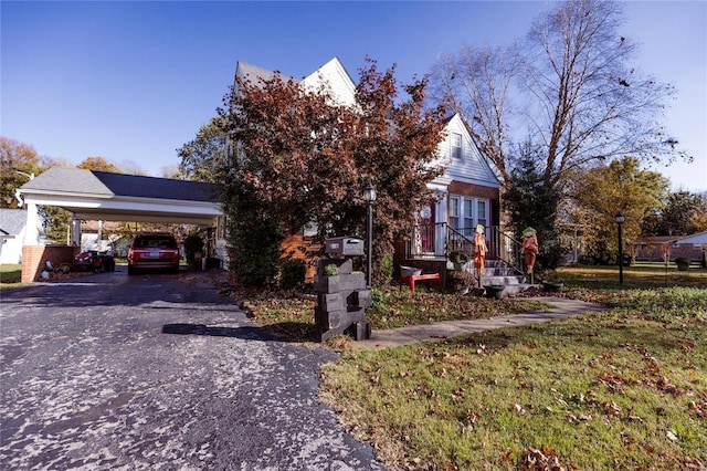 1040 N Kingshighway, Sikeston, MO 63801 - obstructed view of property with a carport, asphalt driveway, and brick siding