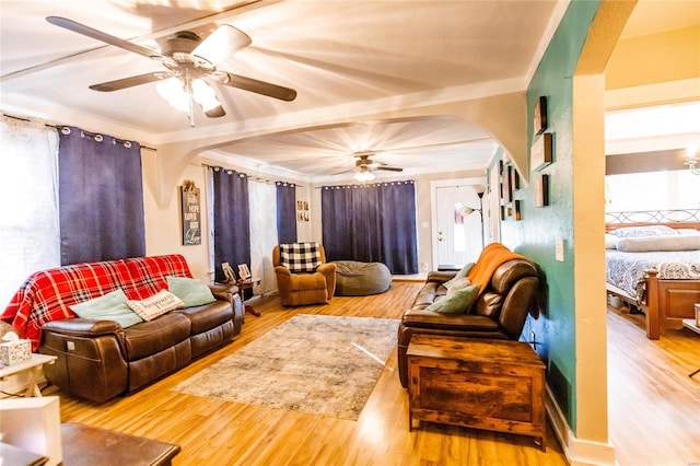 1040 N Kingshighway, Sikeston, MO 63801 - living room featuring arched walkways, a ceiling fan, wood finished floors, ornamental molding, and plenty of natural light