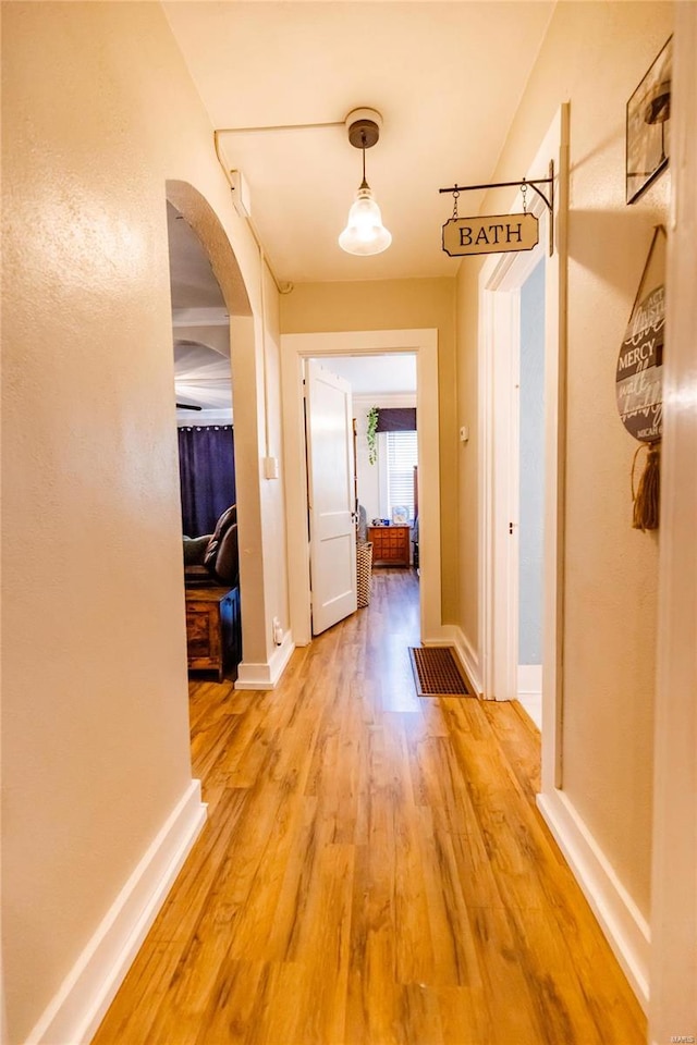 1040 N Kingshighway, Sikeston, MO 63801 - corridor featuring arched walkways, light wood-style flooring, and baseboards