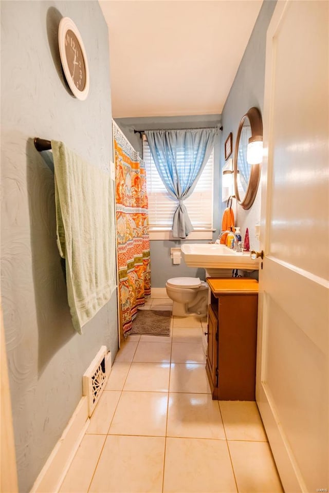 1040 N Kingshighway, Sikeston, MO 63801 - full bathroom featuring toilet, vanity, tile patterned flooring, and baseboards