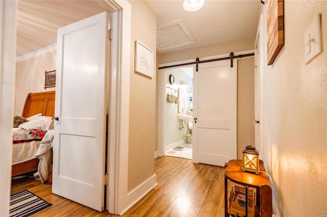 1040 N Kingshighway, Sikeston, MO 63801 - hall featuring light wood finished floors, a barn door, attic access, and baseboards