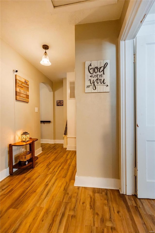 1040 N Kingshighway, Sikeston, MO 63801 - hall featuring arched walkways, light wood-style floors, and baseboards