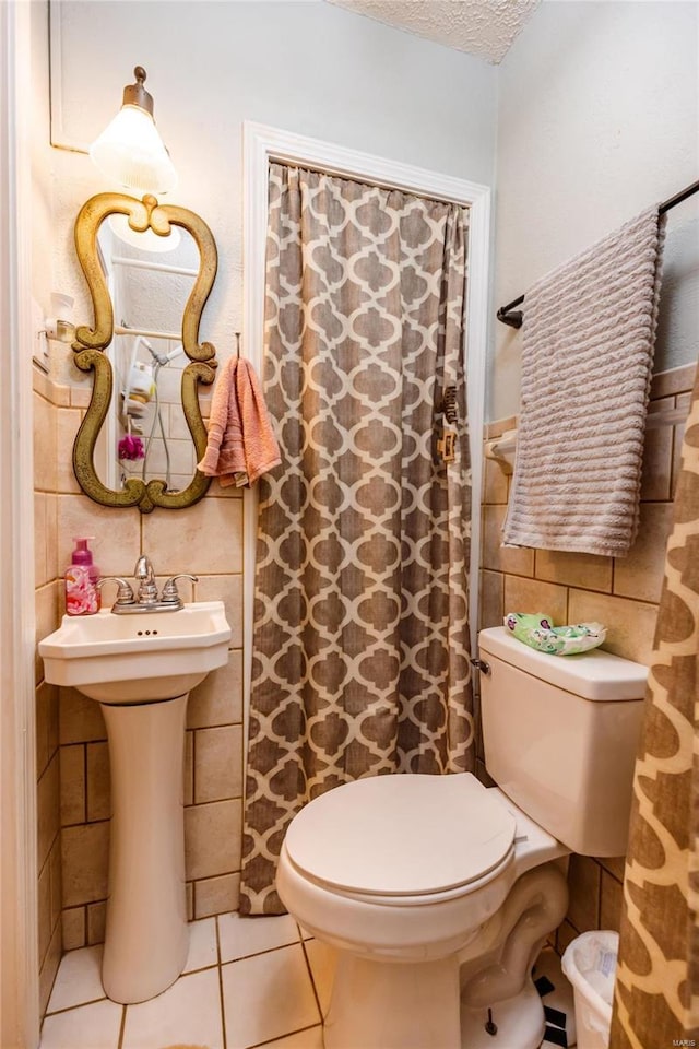 1040 N Kingshighway, Sikeston, MO 63801 - full bathroom featuring tile walls, toilet, tile patterned floors, a textured ceiling, and wainscoting