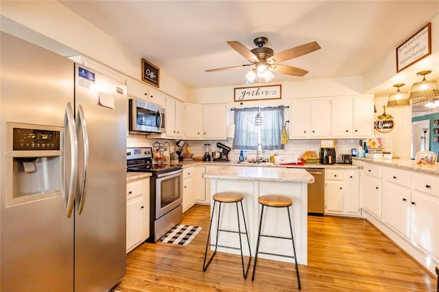 1040 N Kingshighway, Sikeston, MO 63801 - kitchen featuring appliances with stainless steel finishes, tasteful backsplash, and white cabinets