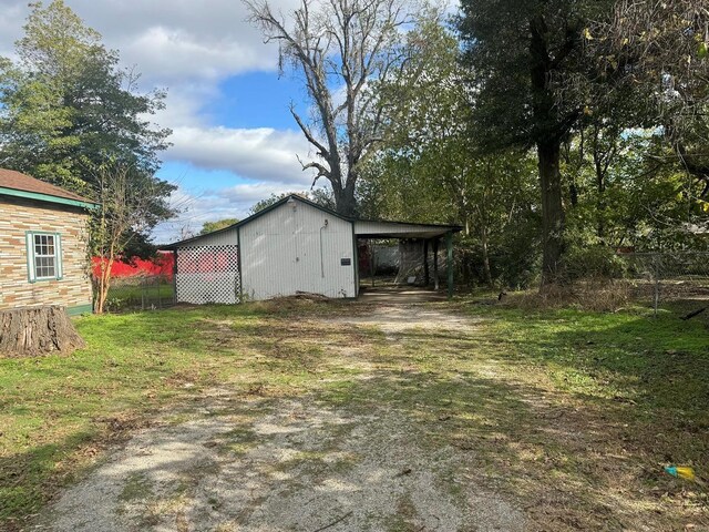 206 Chance St, Kennett, MO 63857 - view of outbuilding featuring a carport