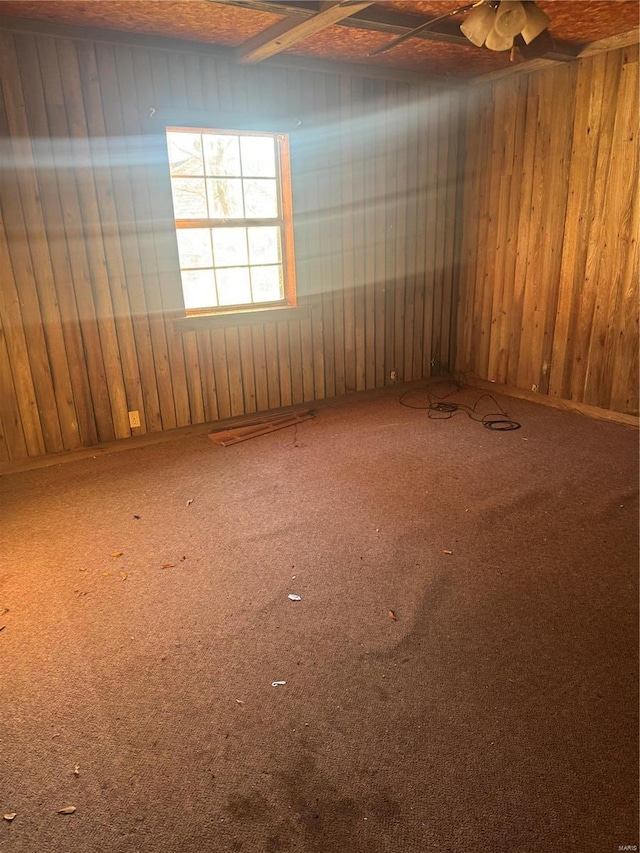 206 Chance St, Kennett, MO 63857 - unfurnished room with carpet floors, wood walls, and ceiling fan