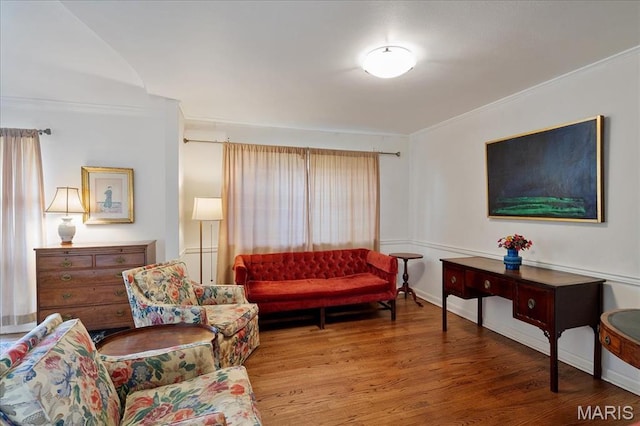 living room featuring ornamental molding and wood finished floors