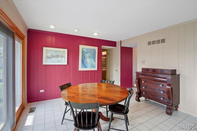 dining area featuring light tile patterned floors, healthy amount of natural light, a decorative wall, recessed lighting, and baseboards