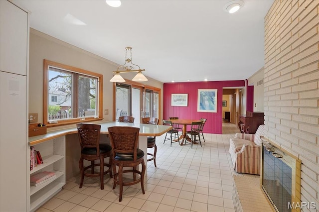 dining space featuring light tile patterned floors, recessed lighting, and ornamental molding