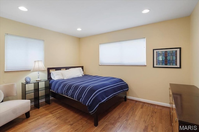 bedroom with light wood-style flooring, baseboards, and recessed lighting