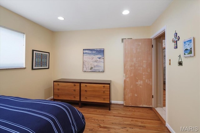 bedroom with wood finished floors, recessed lighting, and baseboards