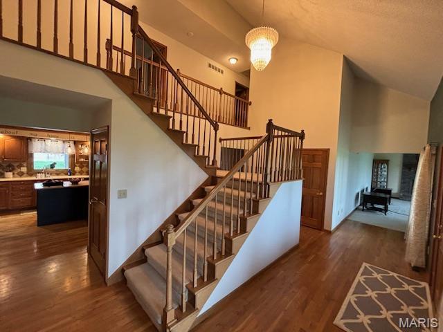 15020 Jamestown Rd, Breese, IL 62230 - stairs featuring wood finished floors and high vaulted ceiling