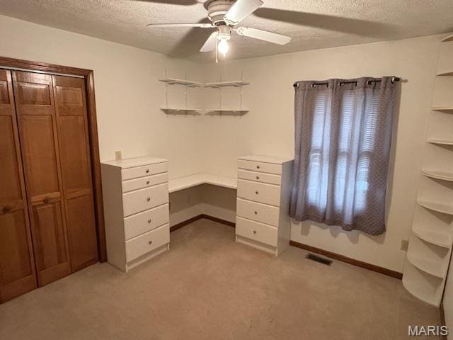 15020 Jamestown Rd, Breese, IL 62230 - unfurnished office with a textured ceiling, a ceiling fan, light colored carpet, baseboards, and built in desk