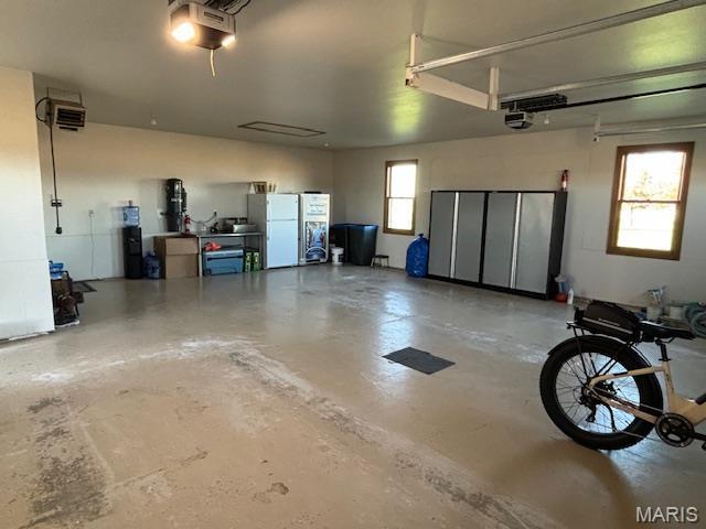 15020 Jamestown Rd, Breese, IL 62230 - garage featuring freestanding refrigerator and a garage door opener