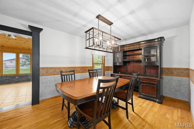 15020 Jamestown Rd, Breese, IL 62230 - dining room featuring wainscoting, a chandelier, light wood-style floors, and tile walls