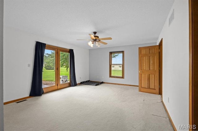 15020 Jamestown Rd, Breese, IL 62230 - empty room with plenty of natural light, carpet floors, ceiling fan, and a textured ceiling