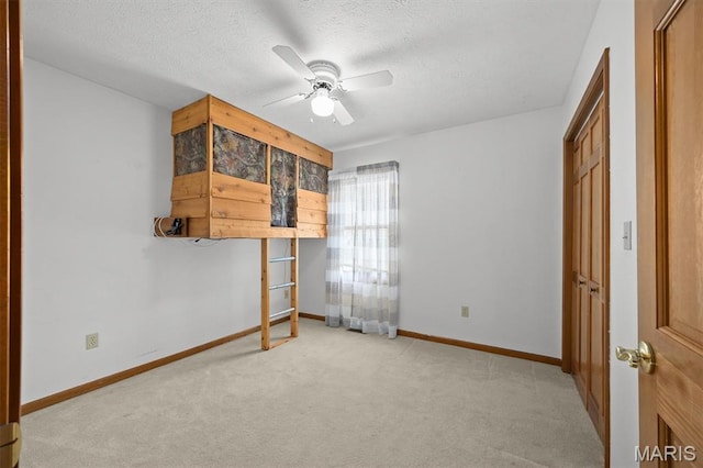 15020 Jamestown Rd, Breese, IL 62230 - unfurnished bedroom featuring light carpet, a textured ceiling, and a ceiling fan