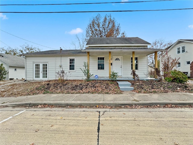 bungalow-style house featuring a porch and french doors