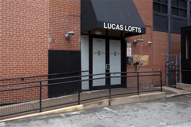 1113 Washington Ave Unit 215, Saint Louis, MO 63101 - view of exterior entry with brick siding and a security system