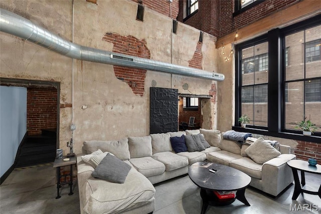 1113 Washington Ave Unit 215, Saint Louis, MO 63101 - living room with a towering ceiling, concrete floors, and a fireplace