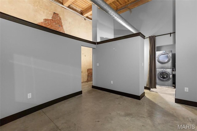 1113 Washington Ave Unit 215, Saint Louis, MO 63101 - empty room with stacked washer / drying machine, finished concrete flooring, and high vaulted ceiling