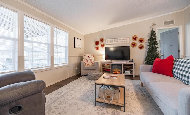 704 Ogle Dr, Richland, MO 65556 - living area featuring crown molding, wood finished floors, a textured ceiling, and baseboards