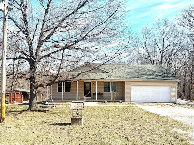 2560 Birch St, Doe Run, MO 63637 - ranch-style home with gravel driveway, a storage unit, a porch, a garage, and a front yard