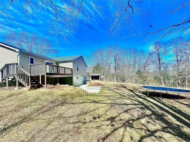 2560 Birch St, Doe Run, MO 63637 - view of yard featuring a trampoline, a wooden deck, and stairs