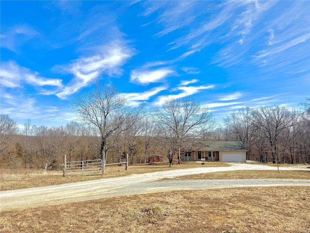 2560 Birch St, Doe Run, MO 63637 - ranch-style house featuring dirt driveway, a garage, and fence