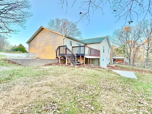 2560 Birch St, Doe Run, MO 63637 - rear view of property featuring a wooden deck, stairway, and a lawn