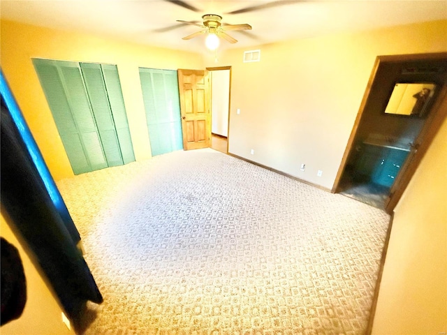2560 Birch St, Doe Run, MO 63637 - unfurnished bedroom with multiple closets, a ceiling fan, and carpet floors
