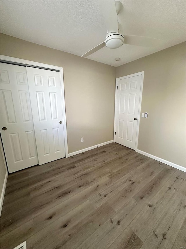 926 Justice Ct, Florissant, MO 63034 - unfurnished bedroom with baseboards, wood finished floors, a closet, a ceiling fan, and a textured ceiling